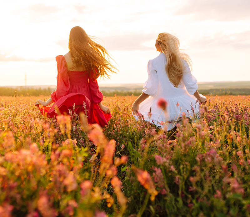 Two Beautiful woman in a field. Nature, fashion, vacation and lifestyle.